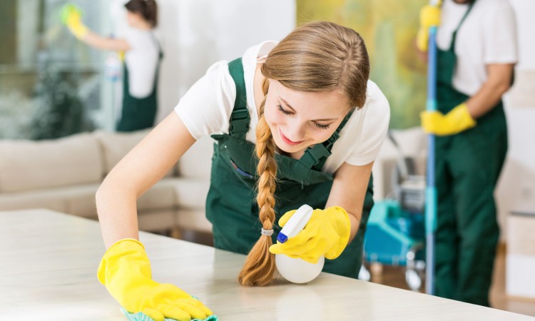 51565922 - smiling cleaning lady in yellow rubber gloves during work